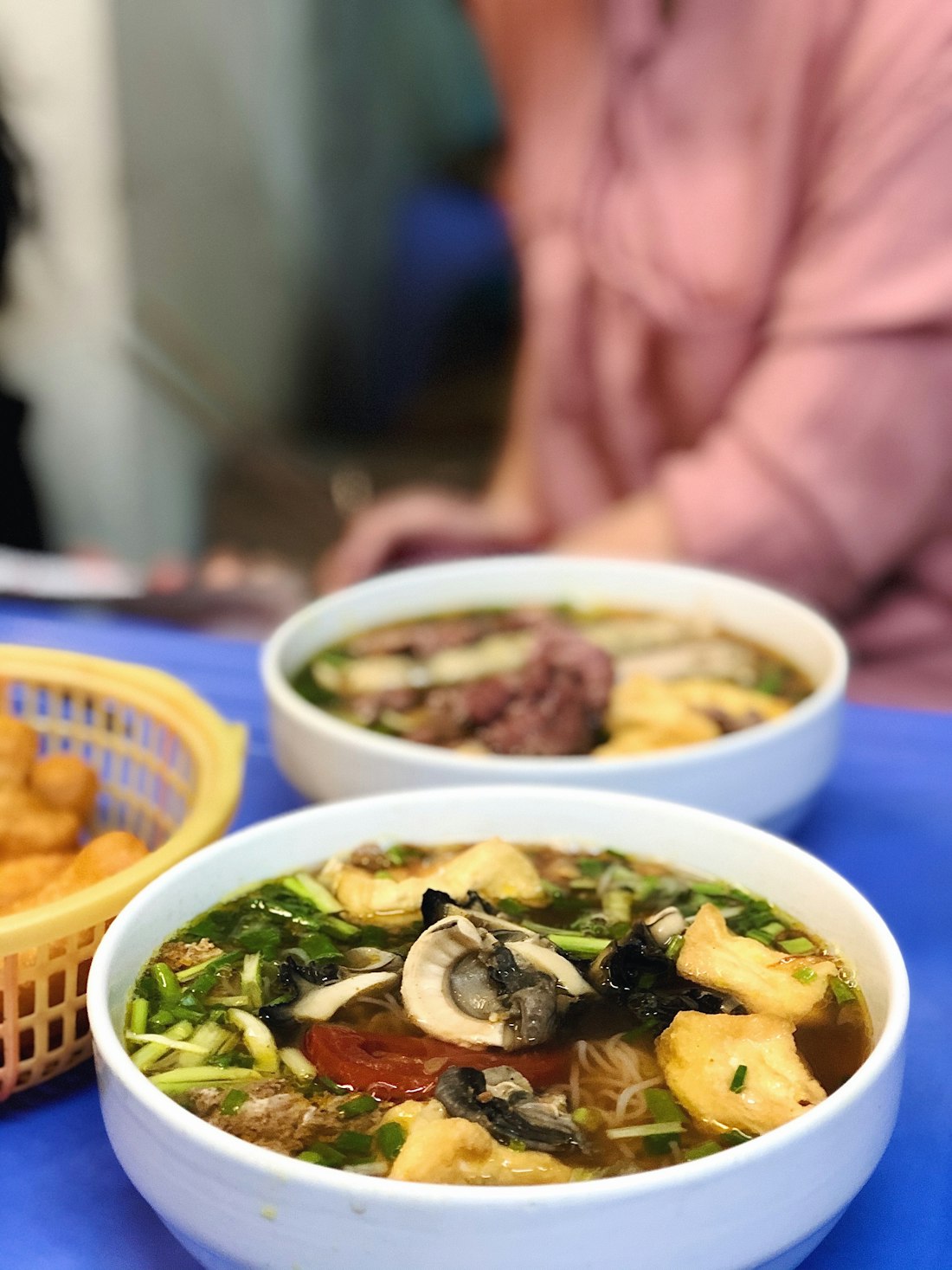 Vietnamese noodle soup served with a generous plate of fresh herbs and condiments