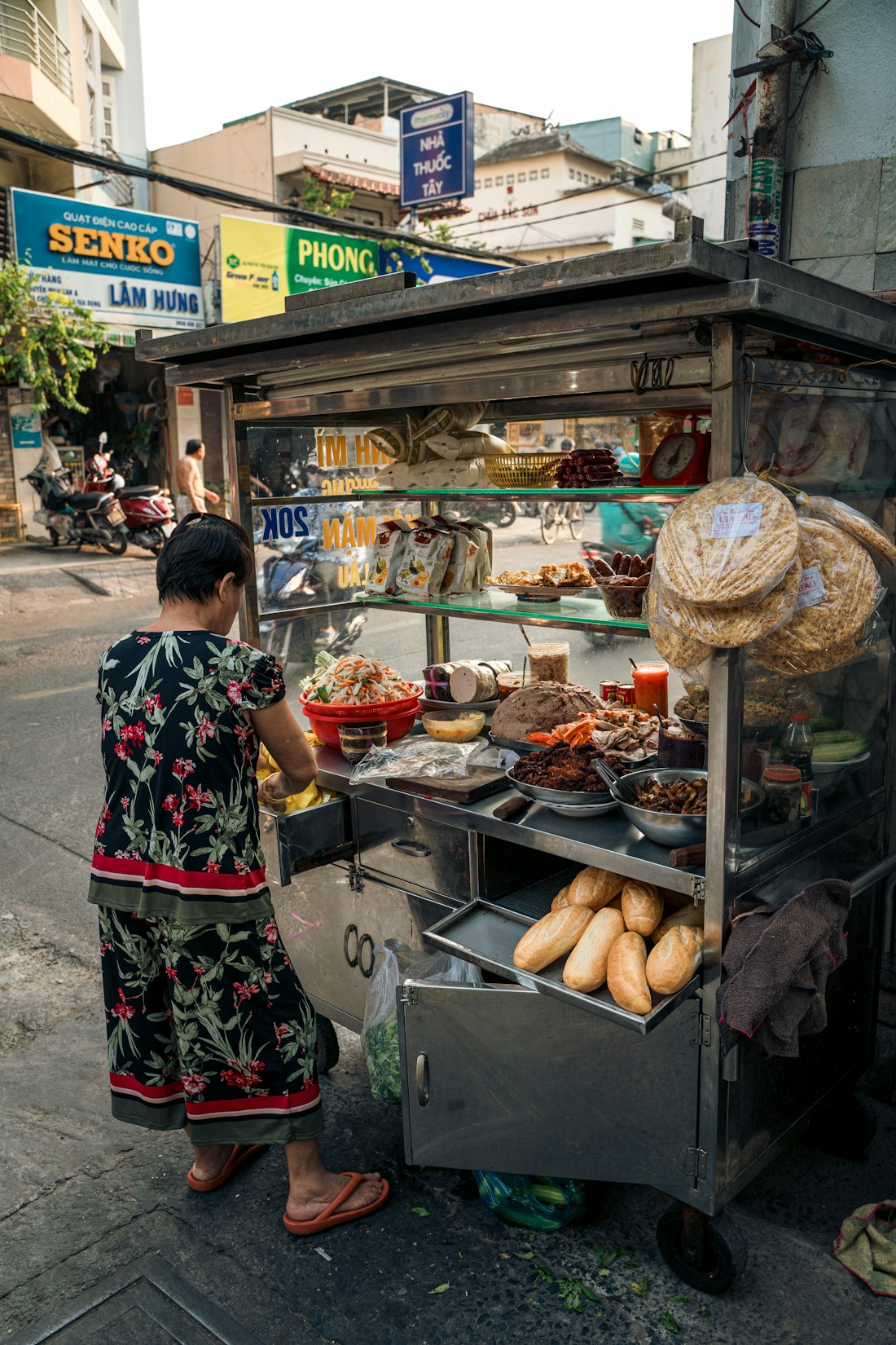 A busy Vietnamese street food stall serving morning bowls — the kind of place where Bún Bò Huế lives