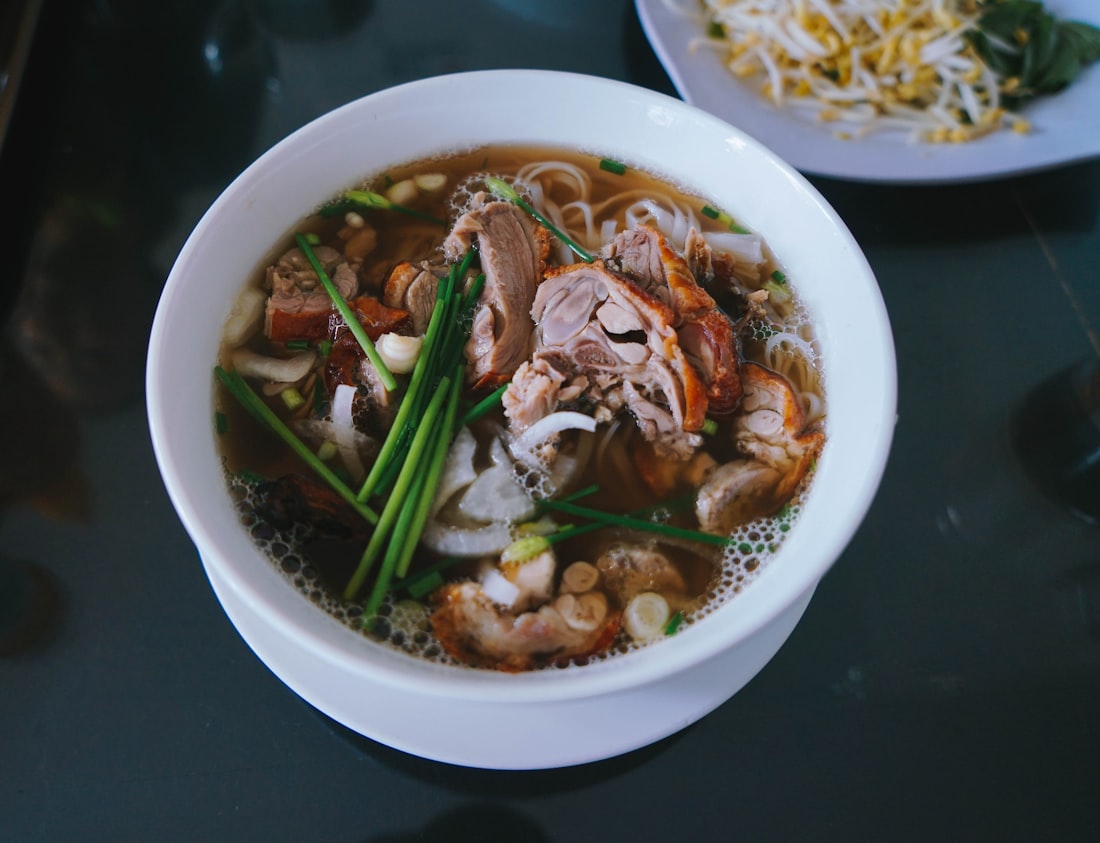 A vibrant Vietnamese noodle dish with beef, fresh herbs, and rich broth